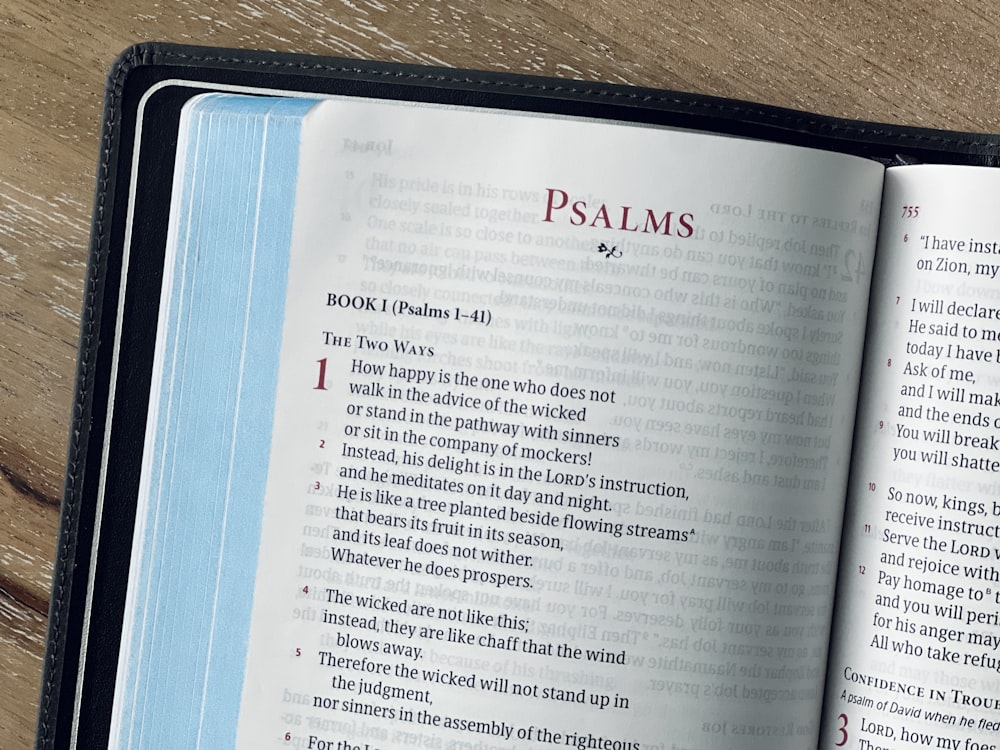 an open bible on a wooden table