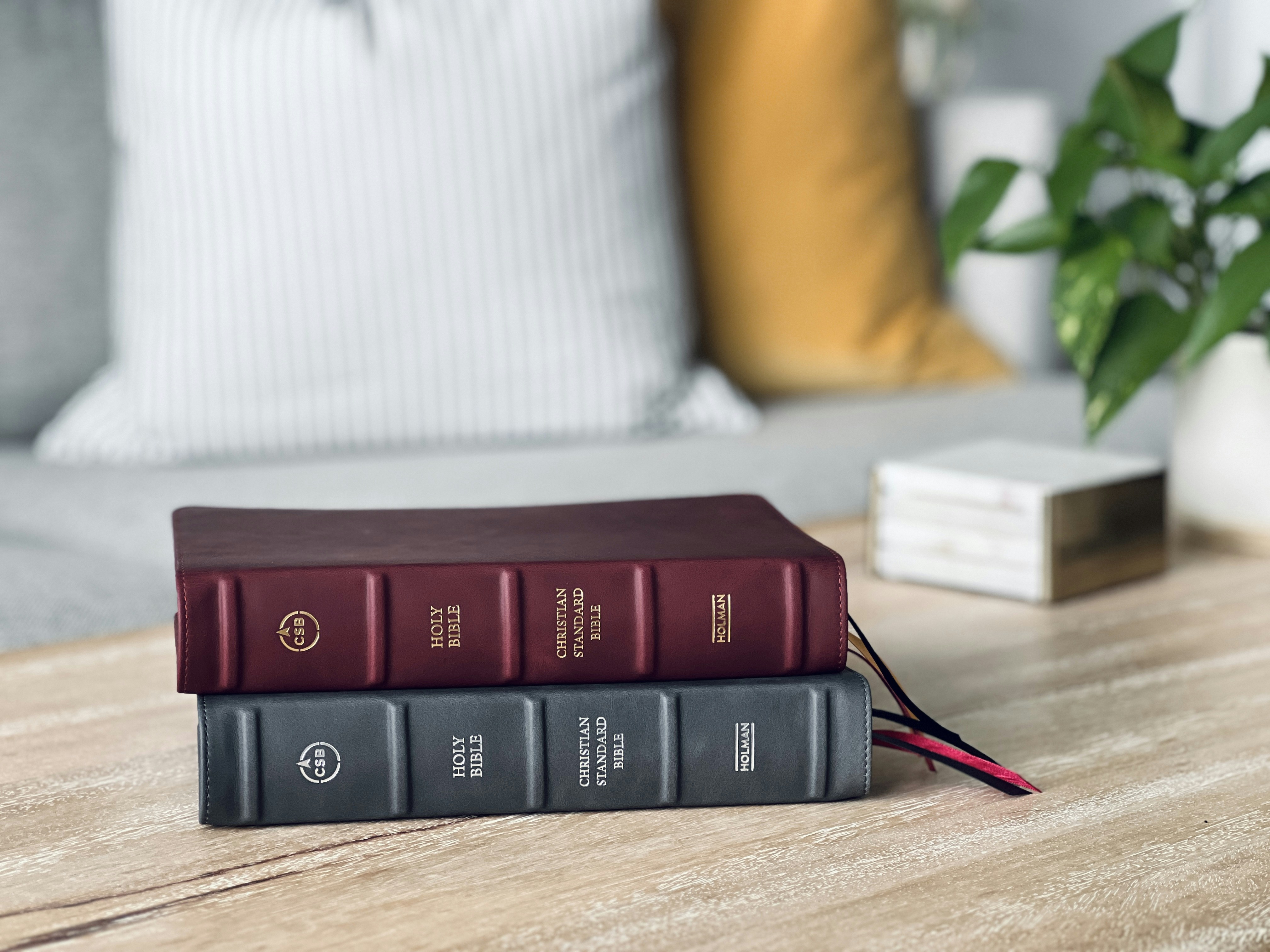 a couple of books sitting on top of a wooden table