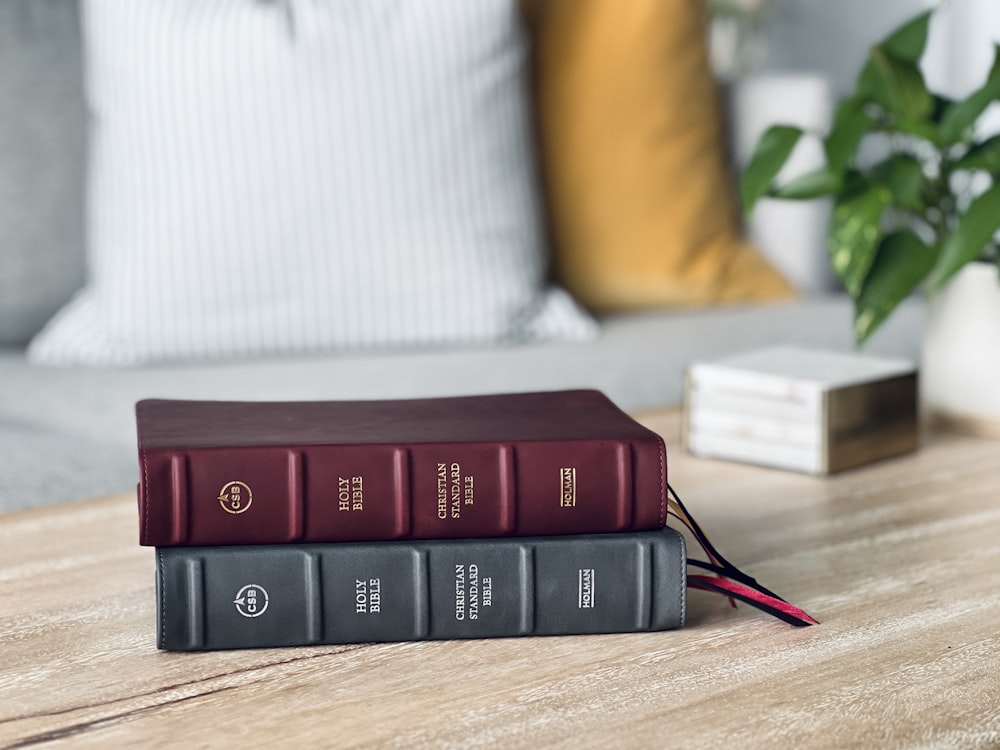 a couple of books sitting on top of a wooden table