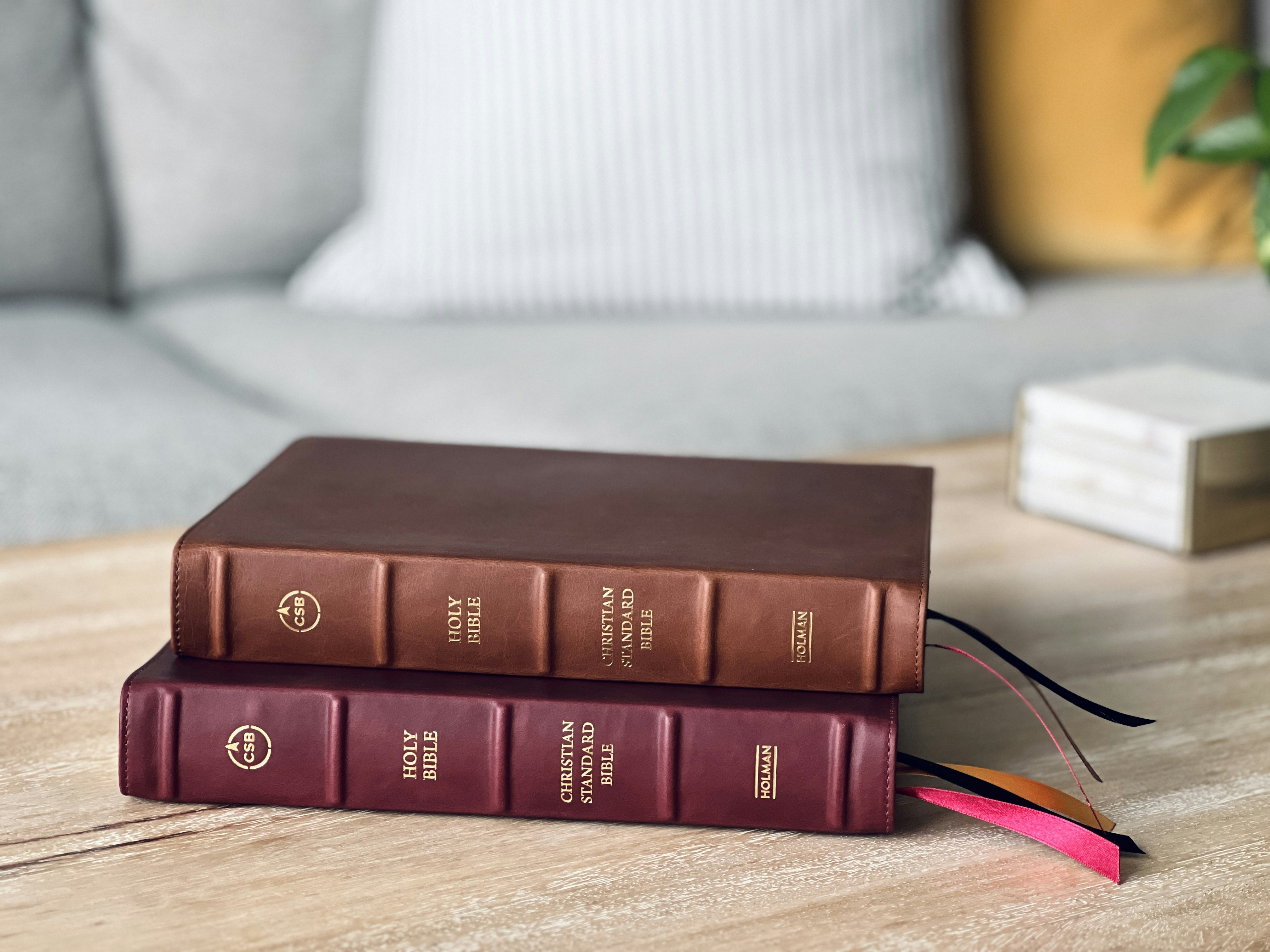 a couple of books sitting on top of a wooden table