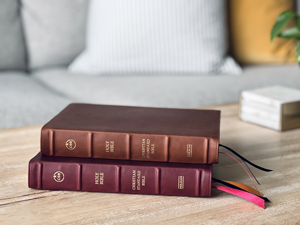 a couple of books sitting on top of a wooden table