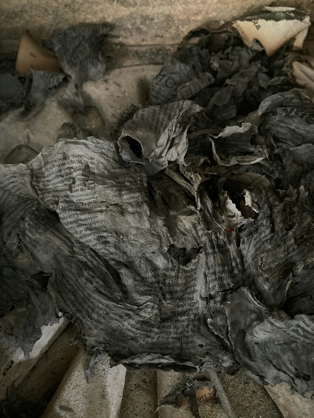 a pile of burned wood sitting on top of a floor