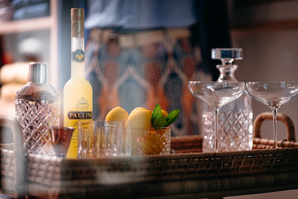 a table topped with glasses and bottles of alcohol