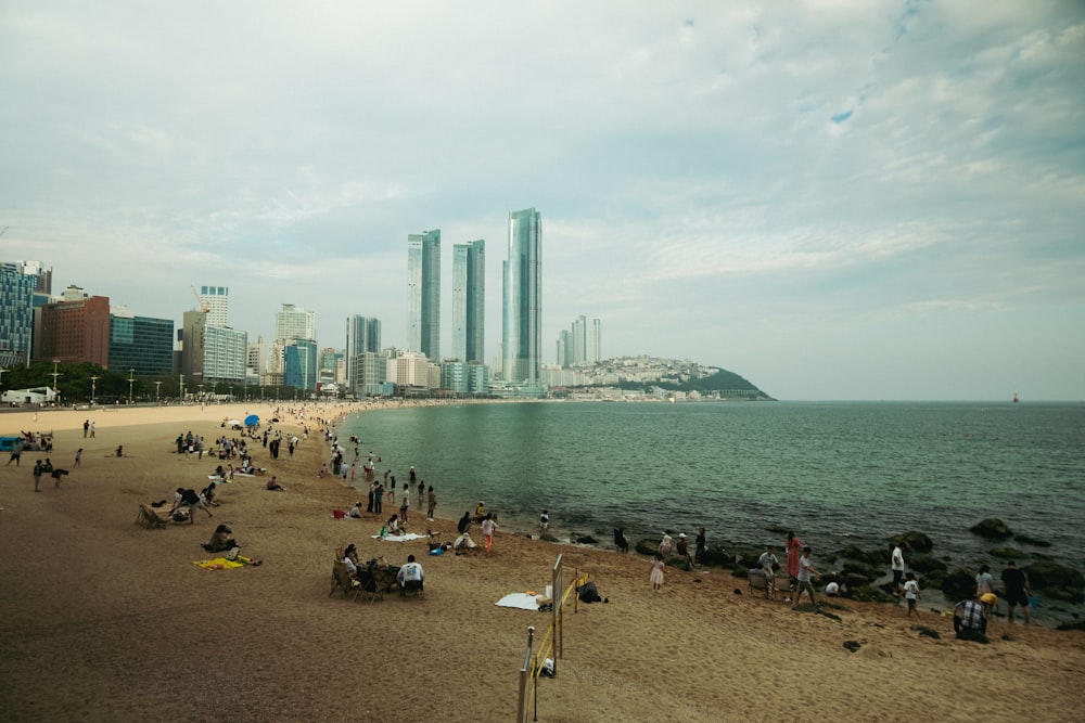 a group of people standing on top of a sandy beach