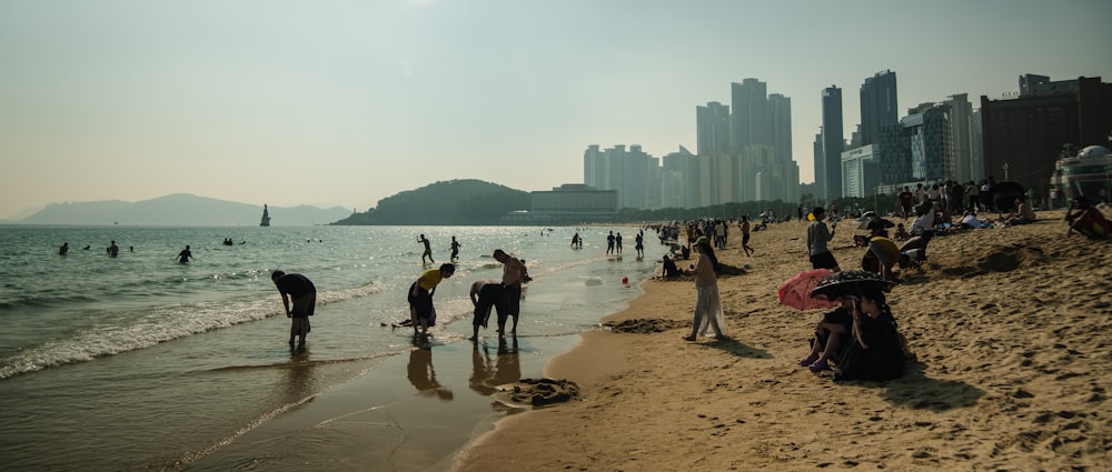 many people are on the beach and in the water