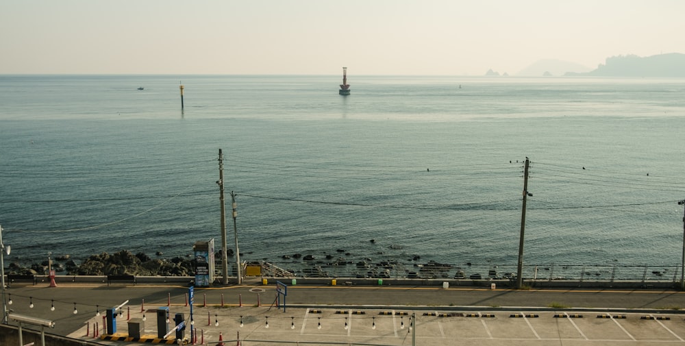 a large body of water with a boat in the distance