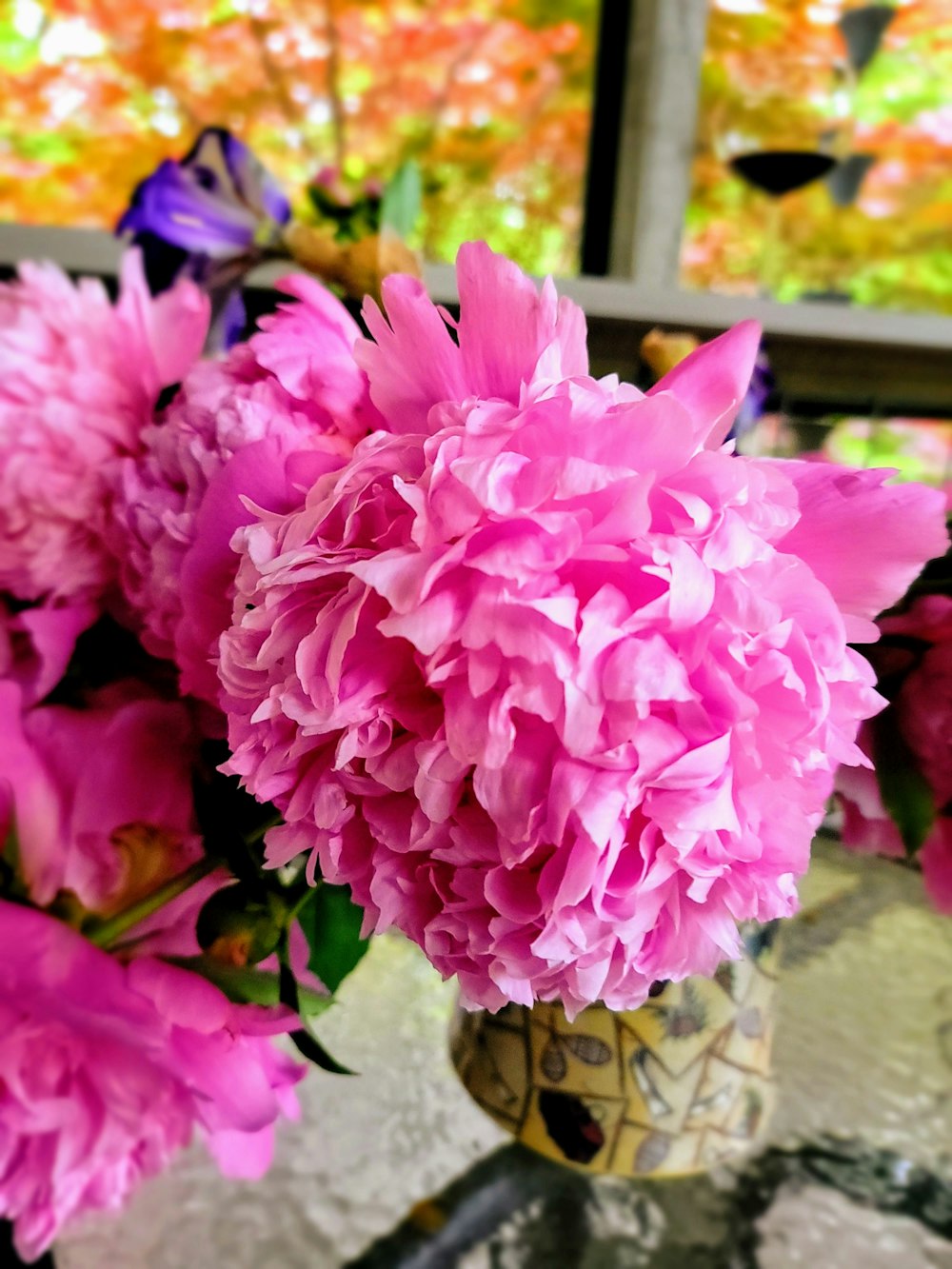 a vase filled with pink flowers on top of a table