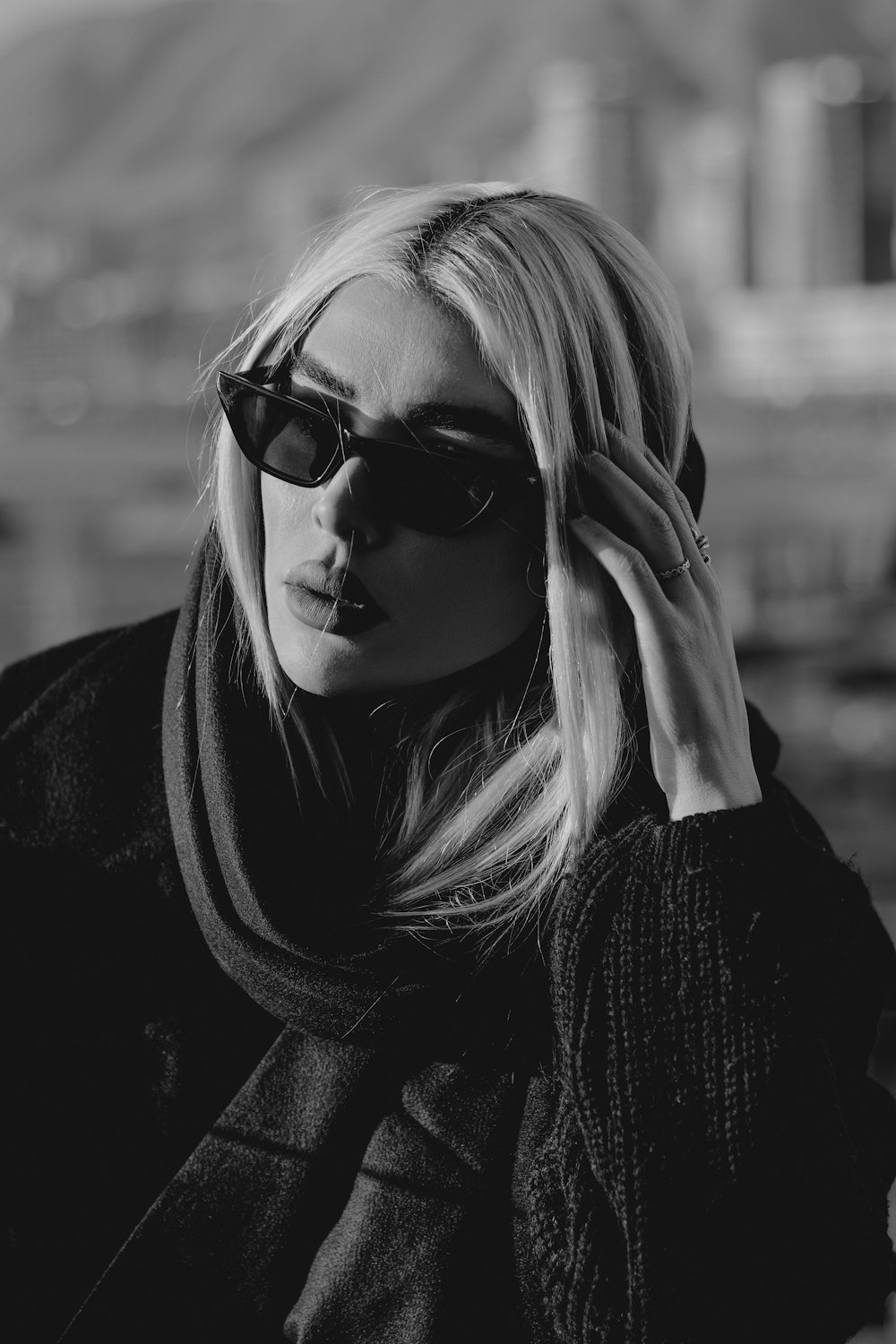 a woman wearing sunglasses and a scarf