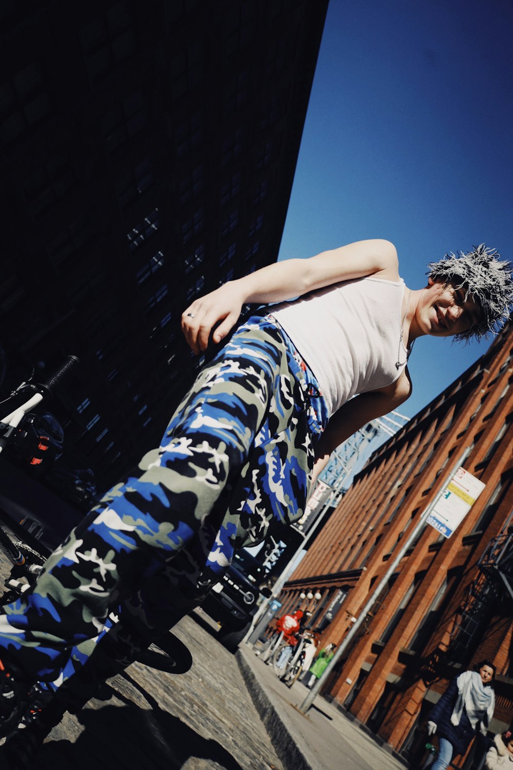 a man riding a skateboard down a street next to a tall building