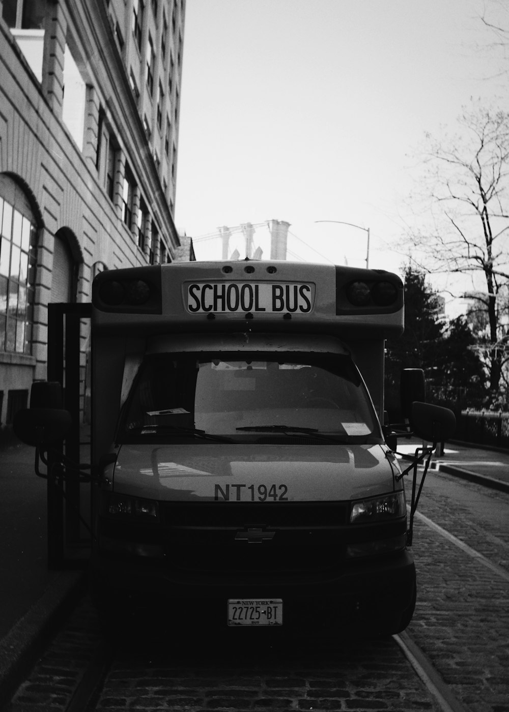 a black and white photo of a school bus