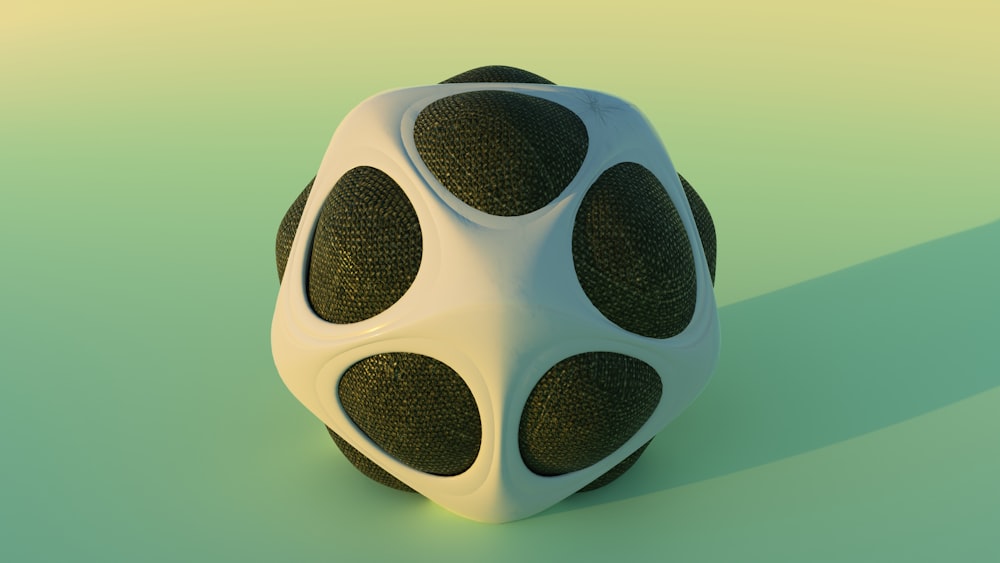 a white and black object sitting on top of a green surface