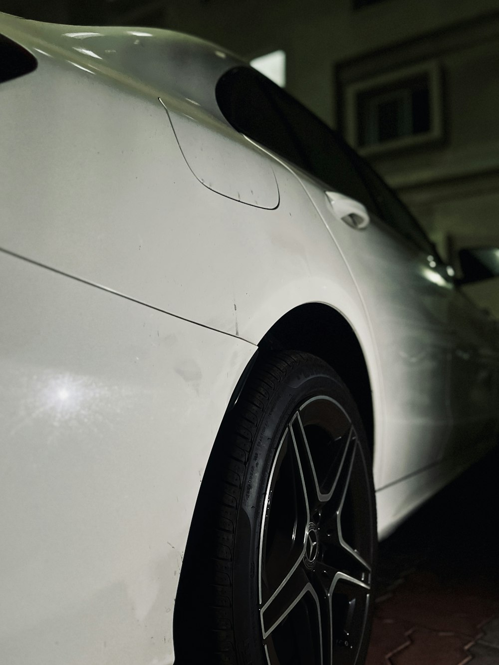 a white sports car parked in a garage