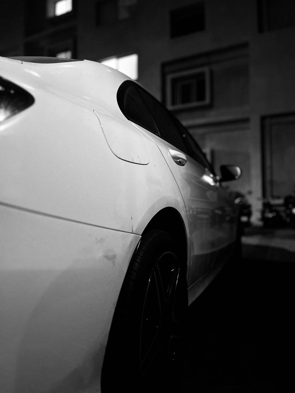 a white car parked in front of a building