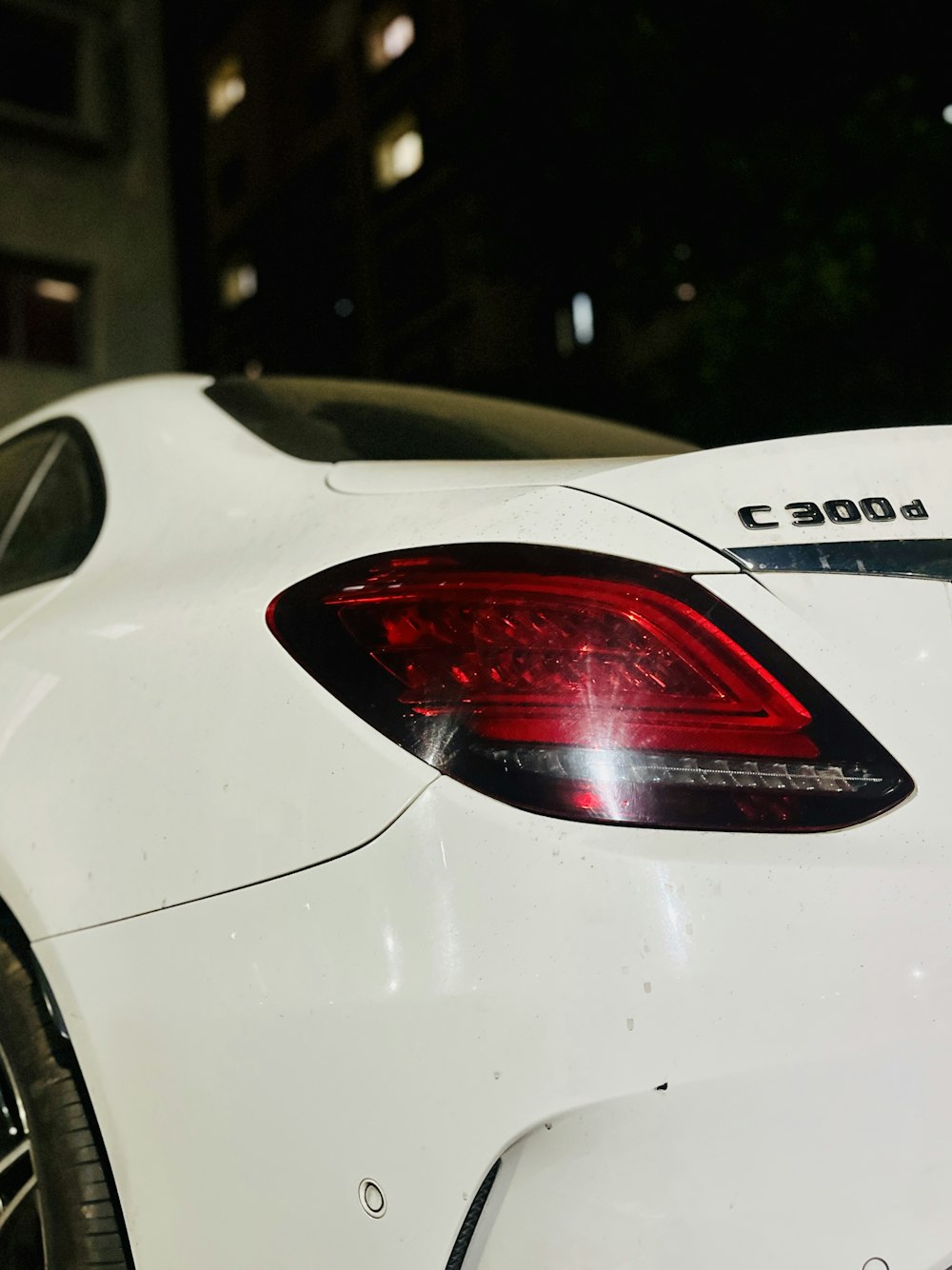 a white sports car parked in a parking lot