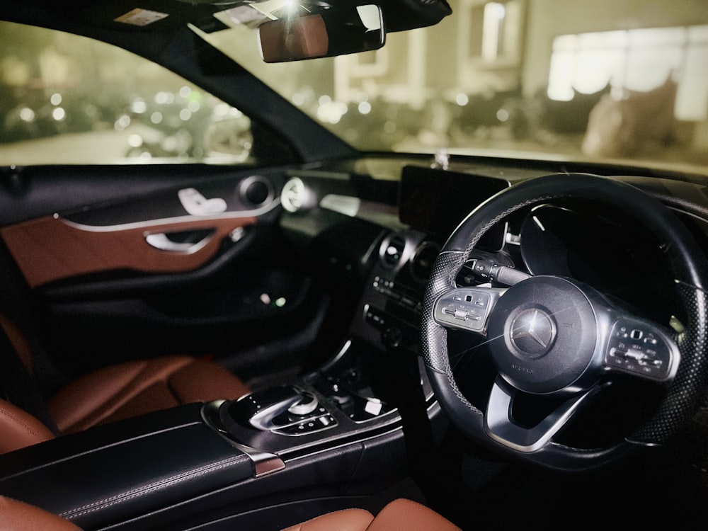 the interior of a car with a steering wheel and dashboard