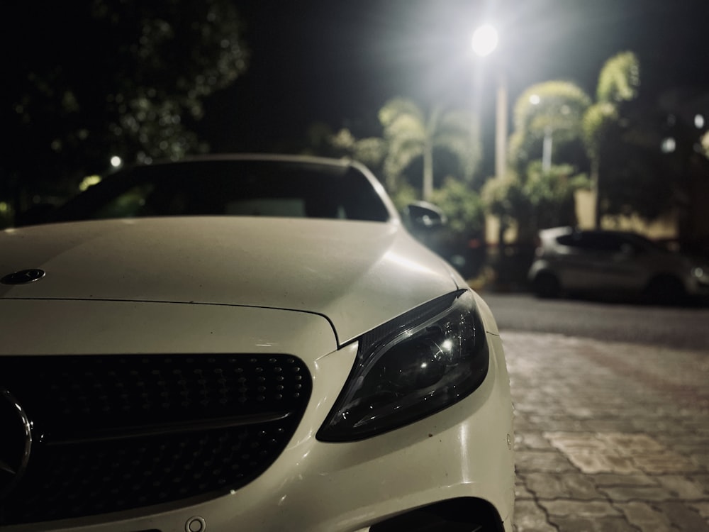 a white car parked on the side of a road