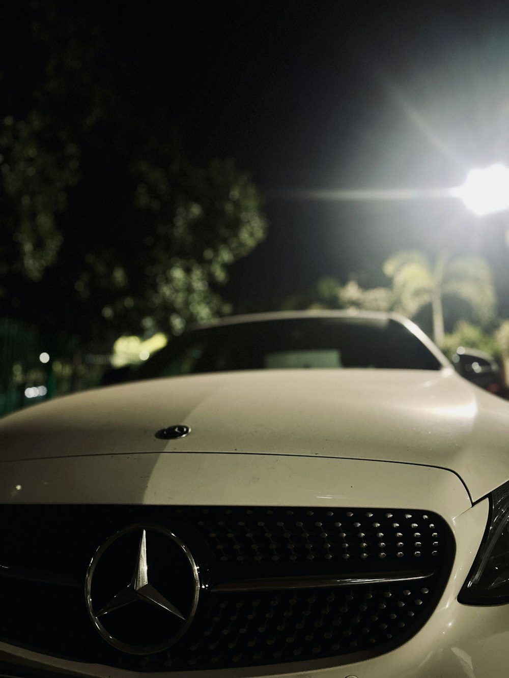 a white car parked in a parking lot at night