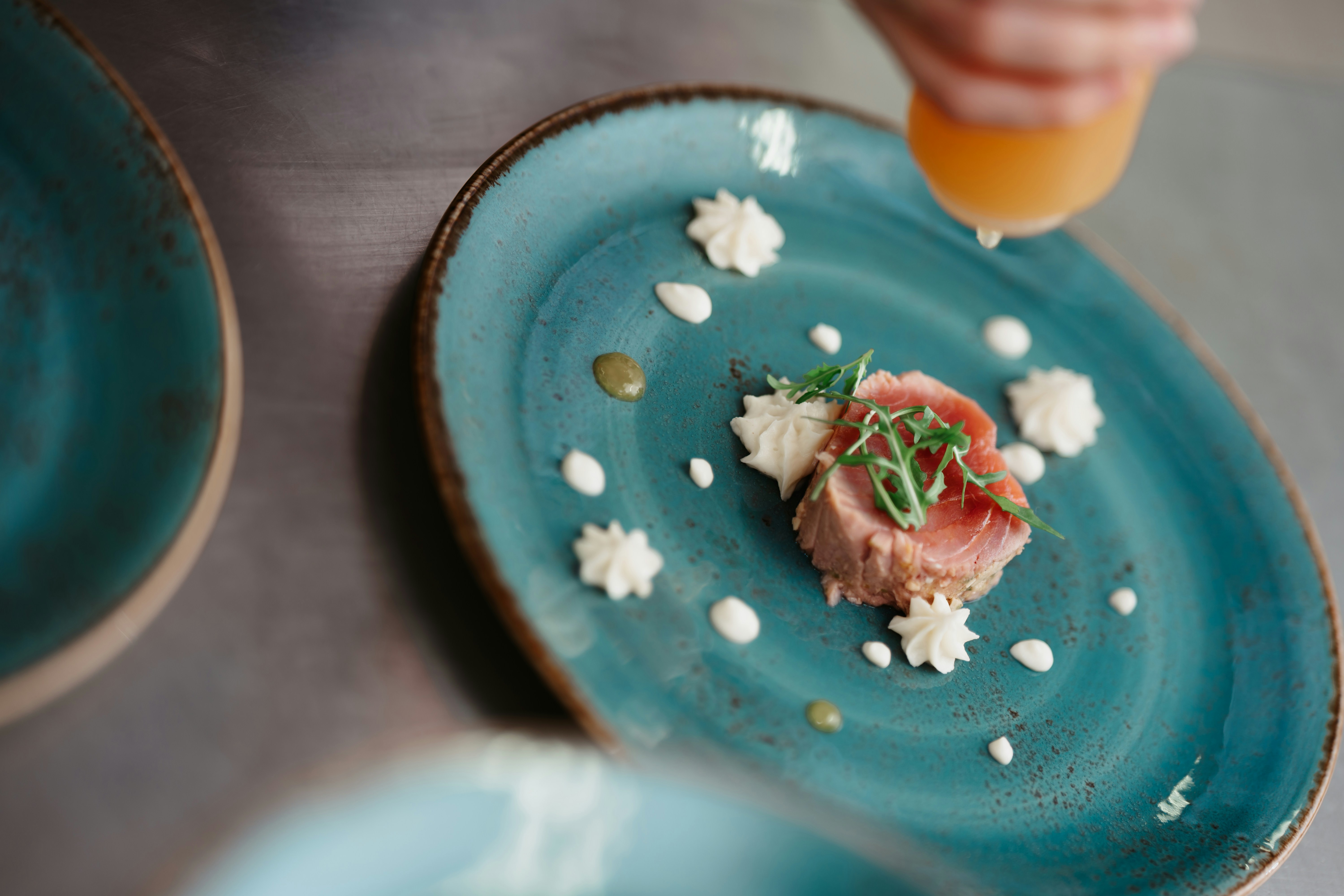 a blue plate with a small piece of food on it