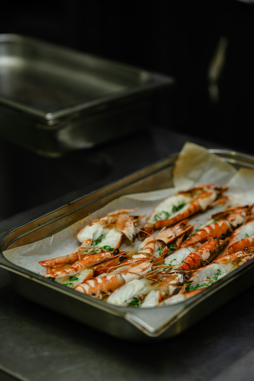 a tray of cooked shrimp on a table