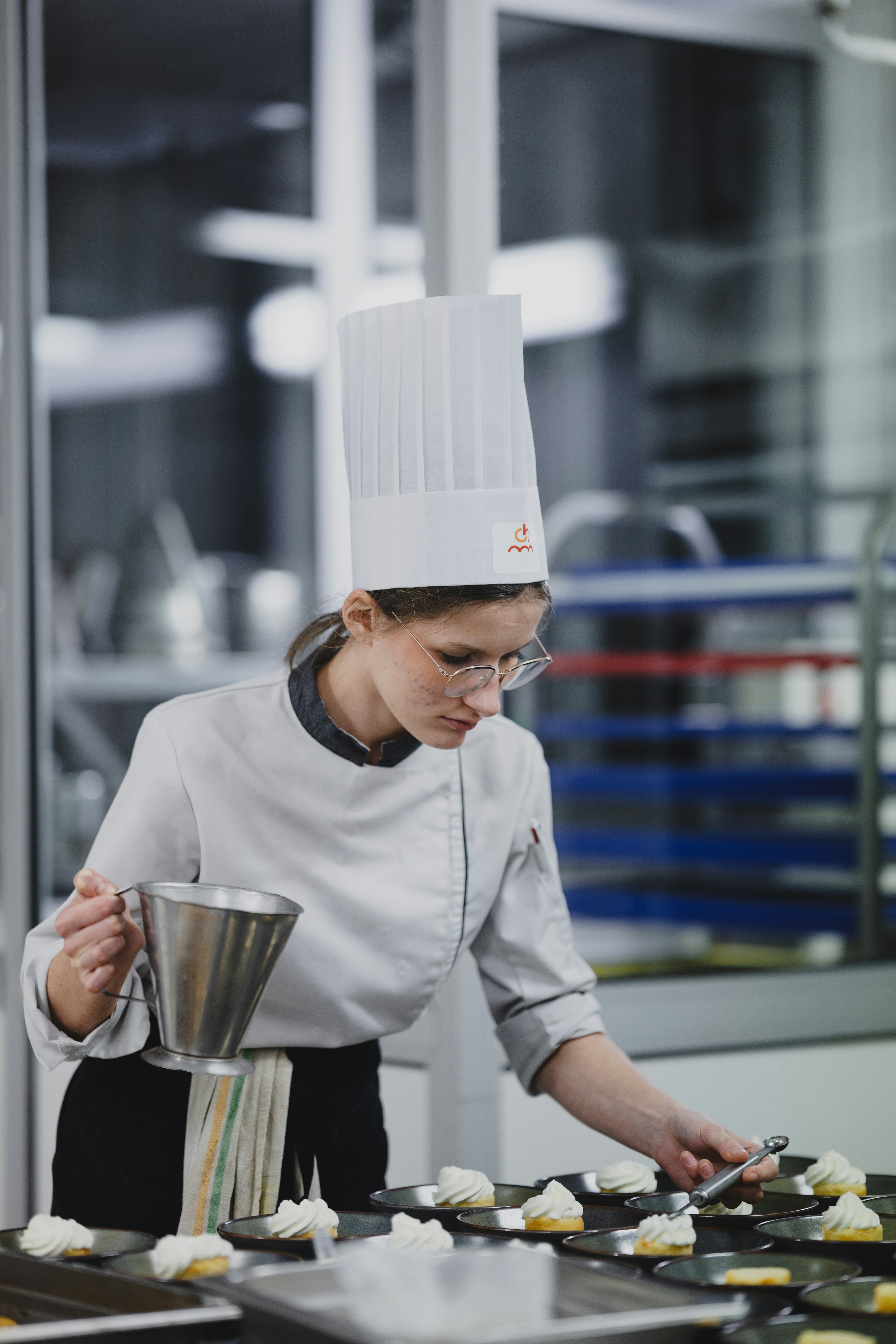 a woman in a chef's hat preparing food in a kitchen