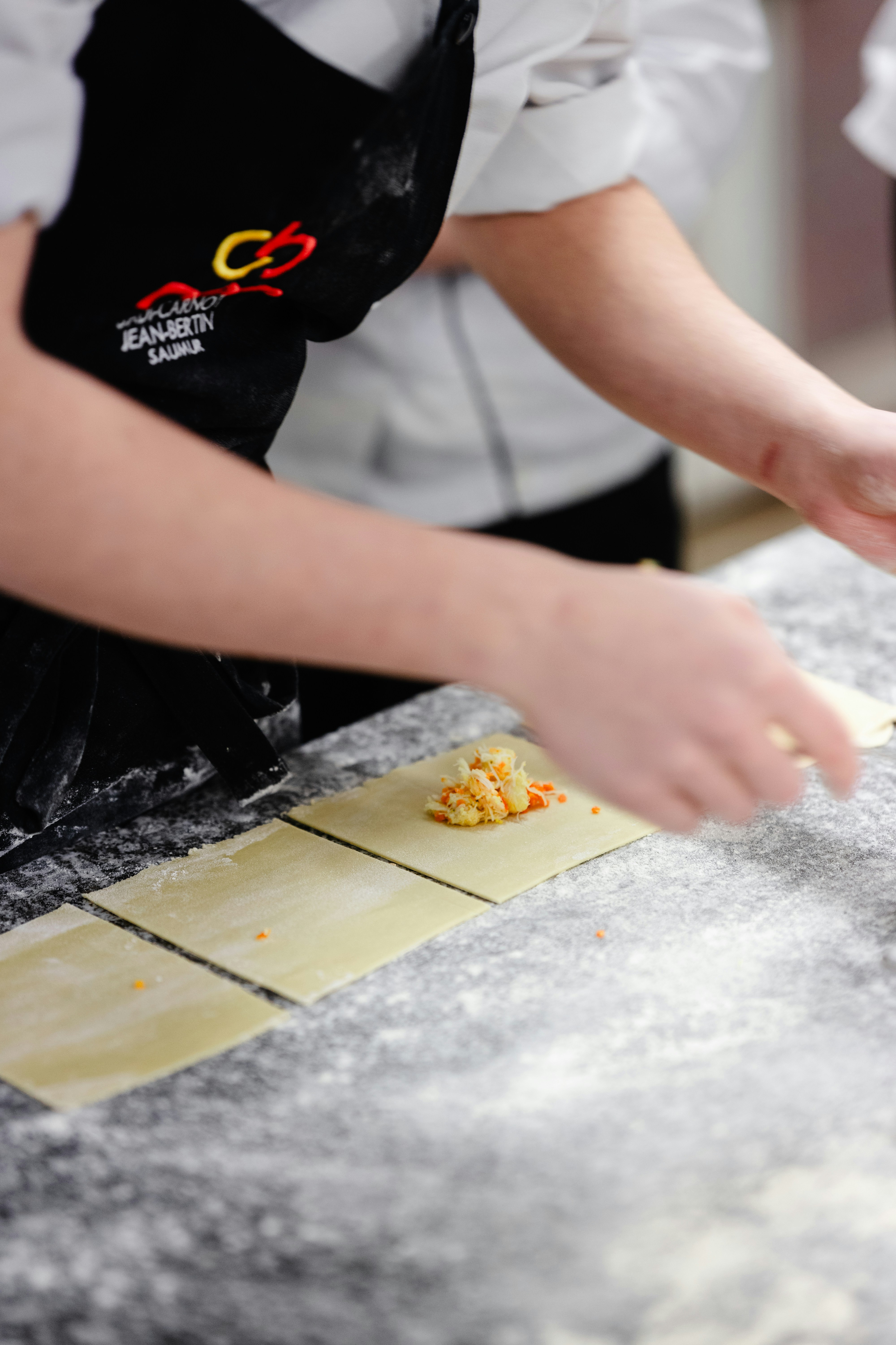 a person in an apron making food on a counter