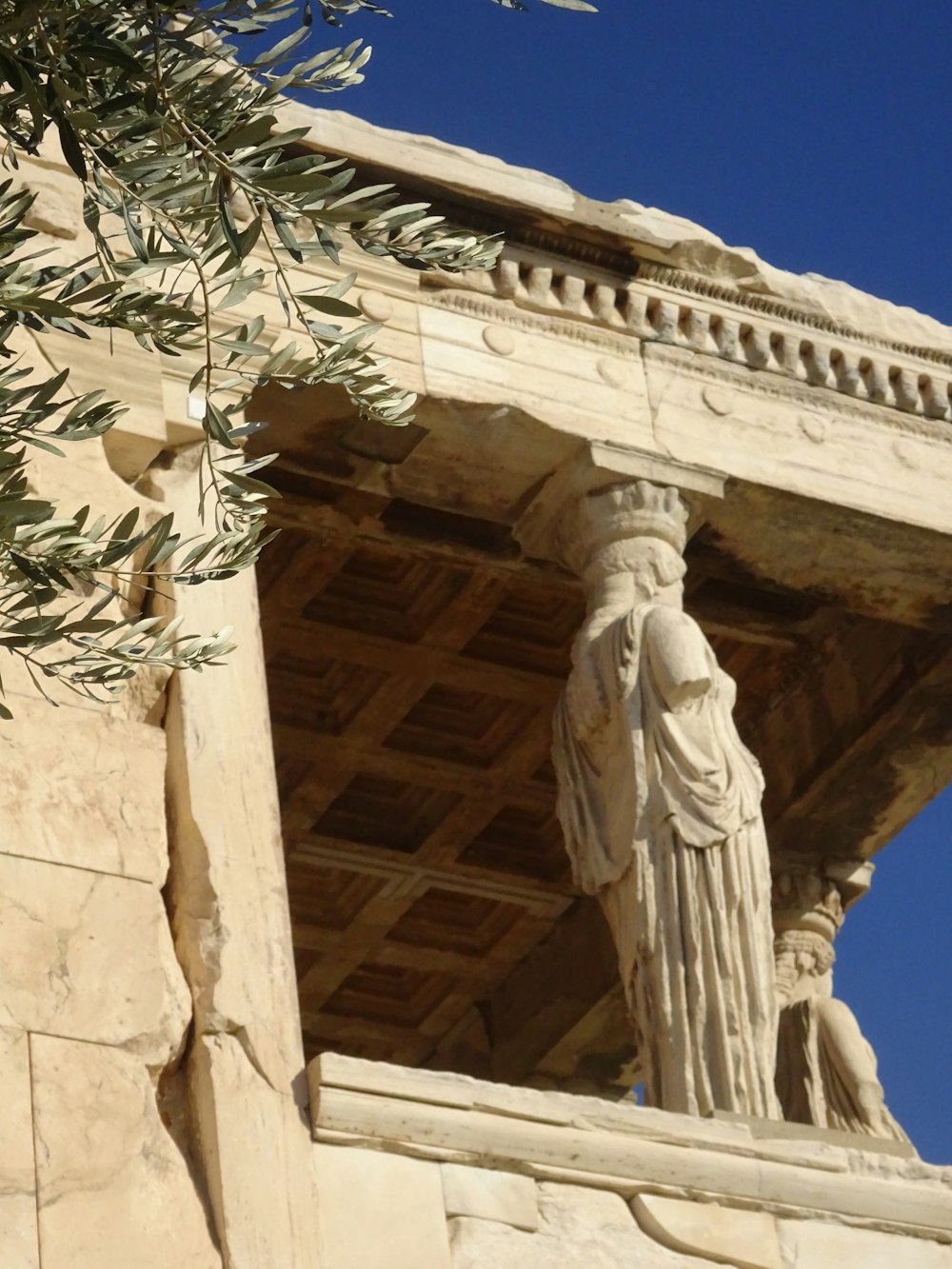 a statue of a woman on a balcony of a building