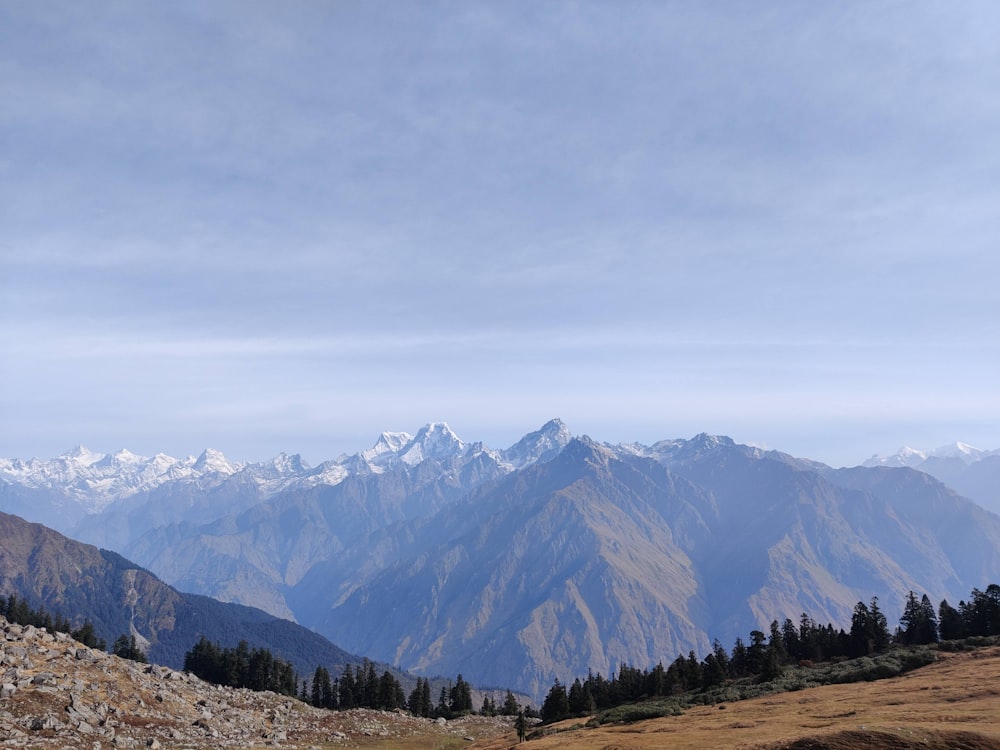 a view of a mountain range with snow capped mountains in the distance