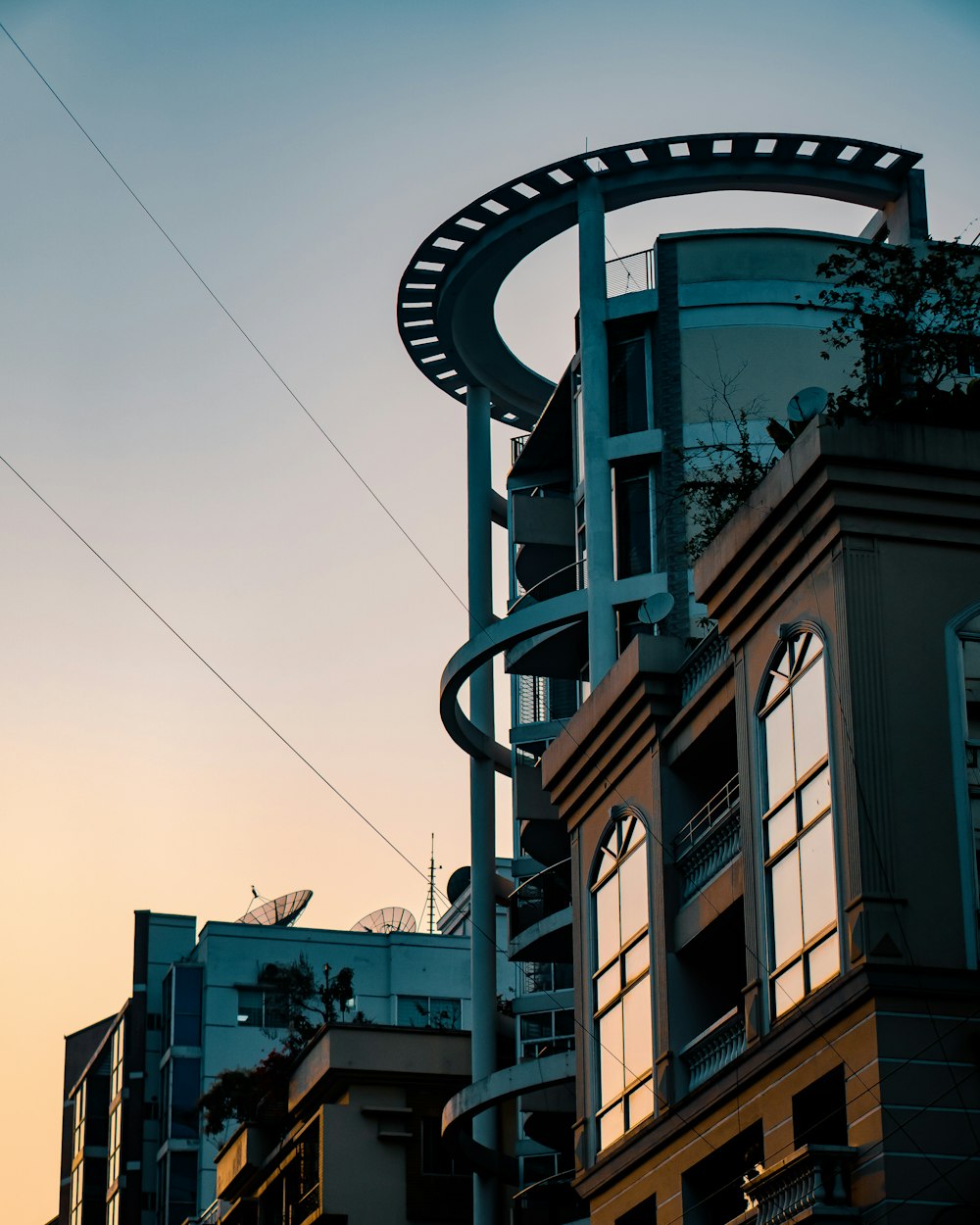 Un edificio alto con una escalera de caracol que sube por el costado