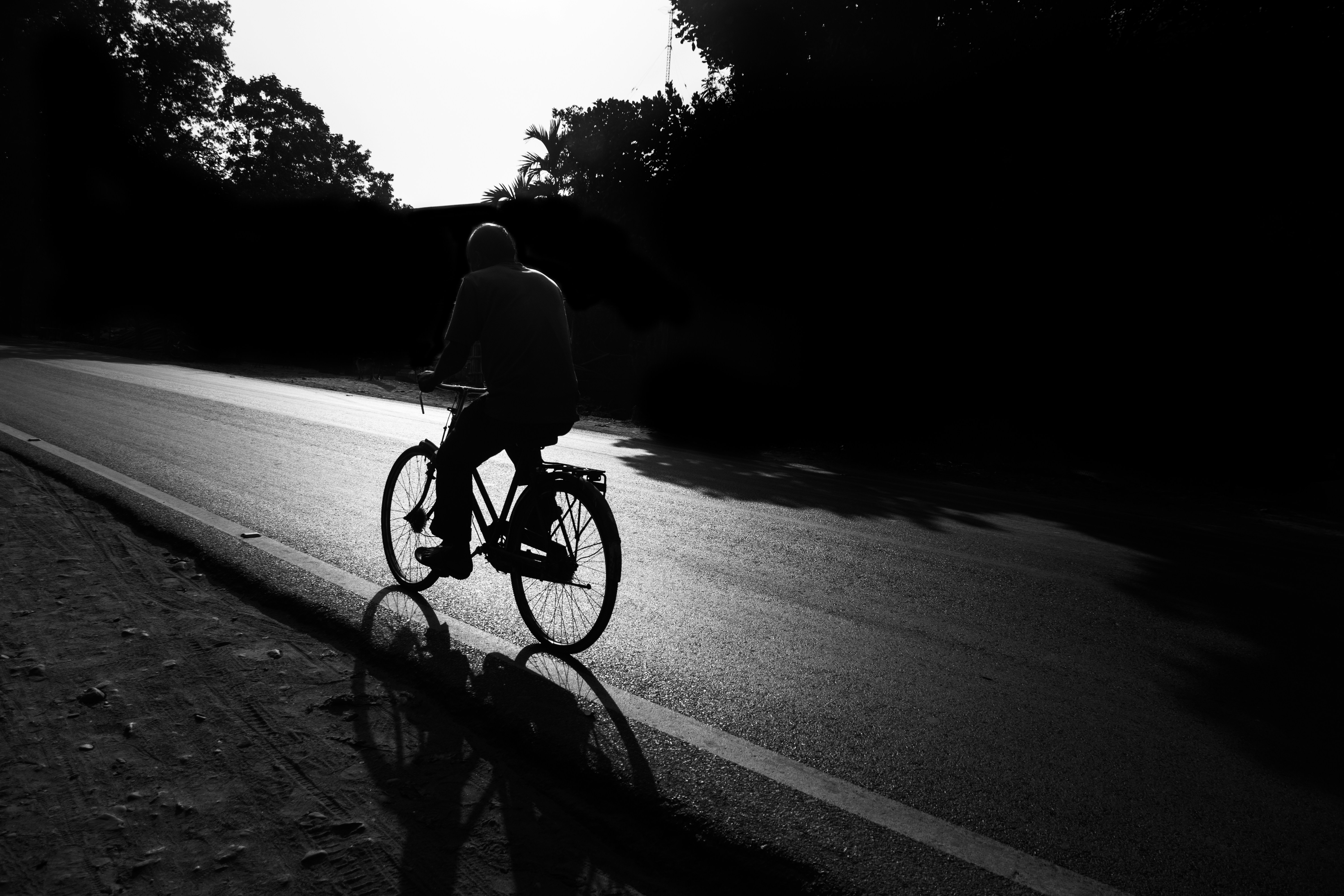 a person riding a bike down a street