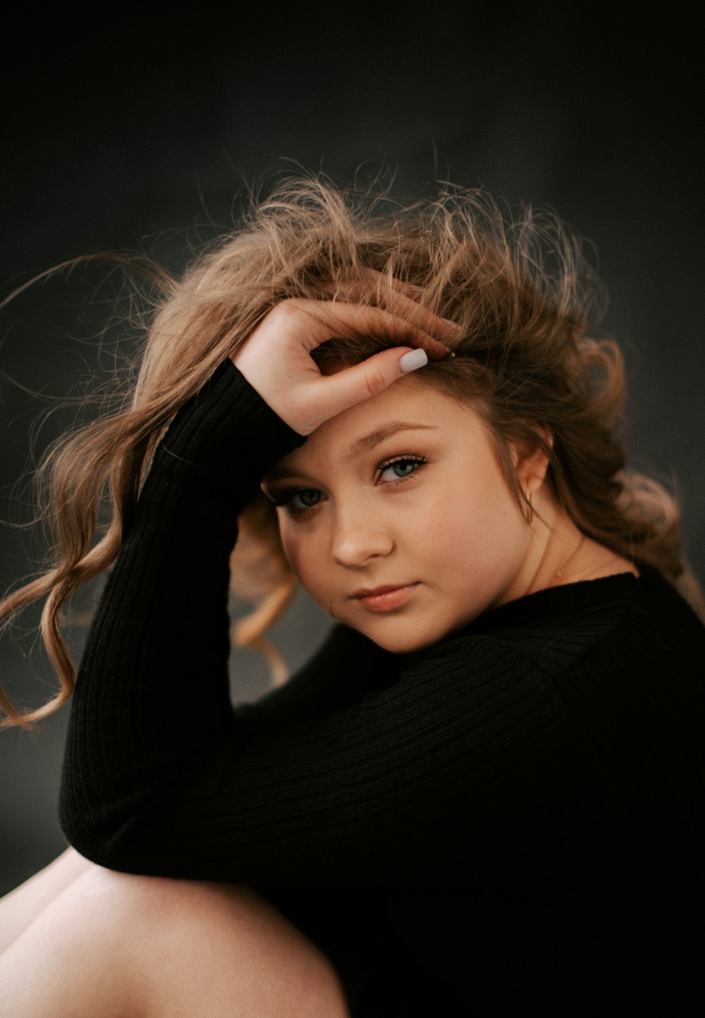 a young girl is posing for a picture