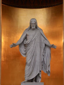 a statue of jesus in a golden room