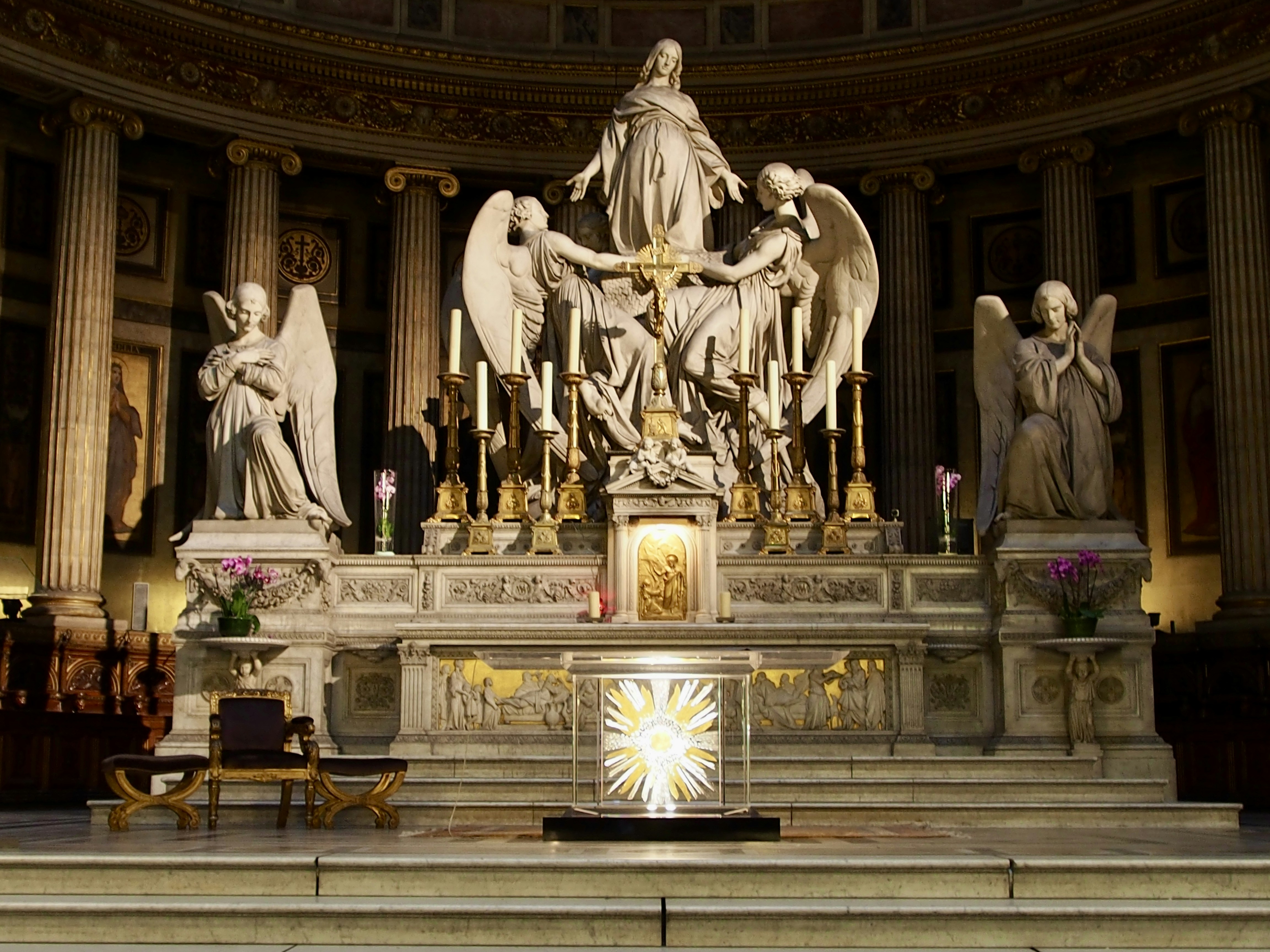 a statue of jesus surrounded by angels in a church