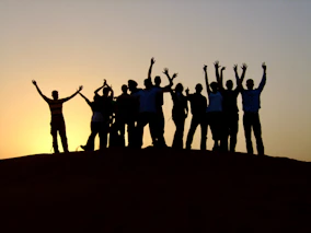 a group of people standing on top of a hill