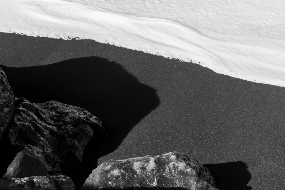 a black and white photo of rocks and snow