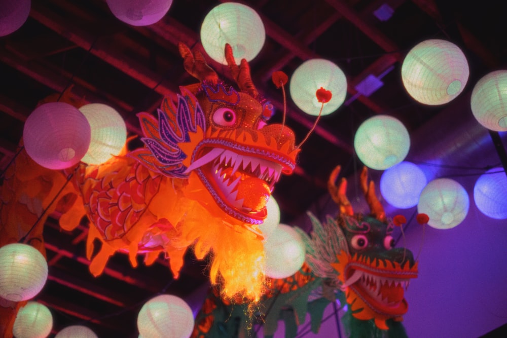 a dragon and a dragon head are lit up at night