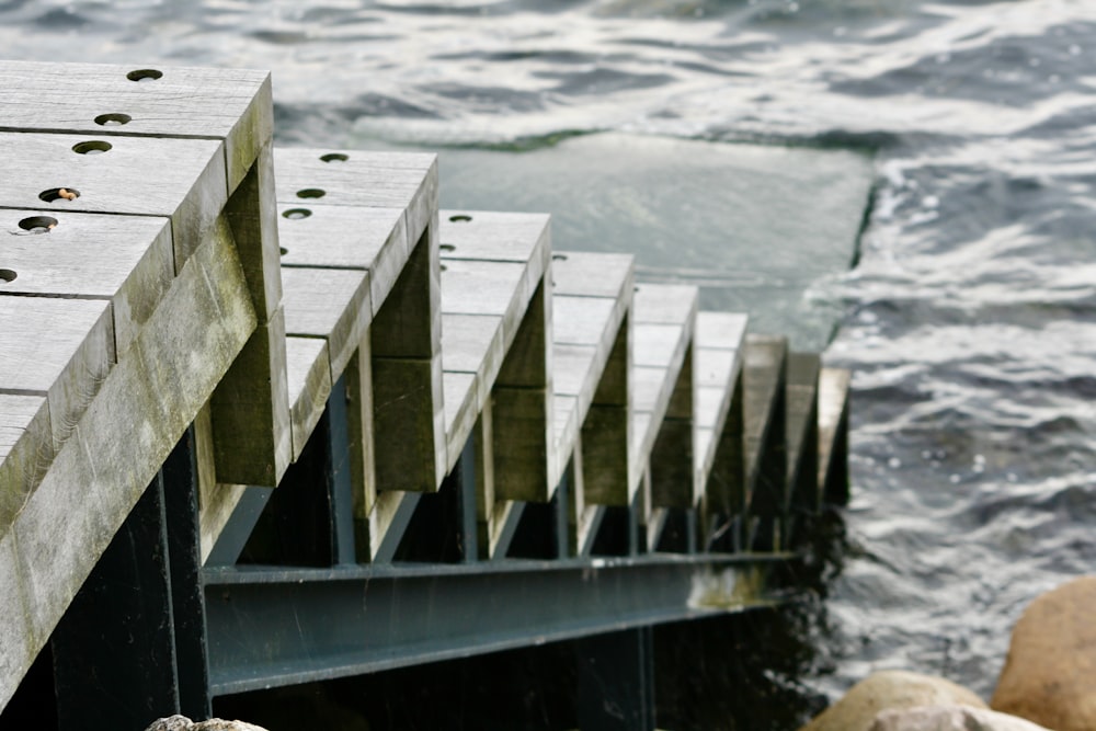 a close up of a wooden dock near the water