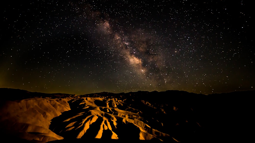 a night sky filled with stars above a desert