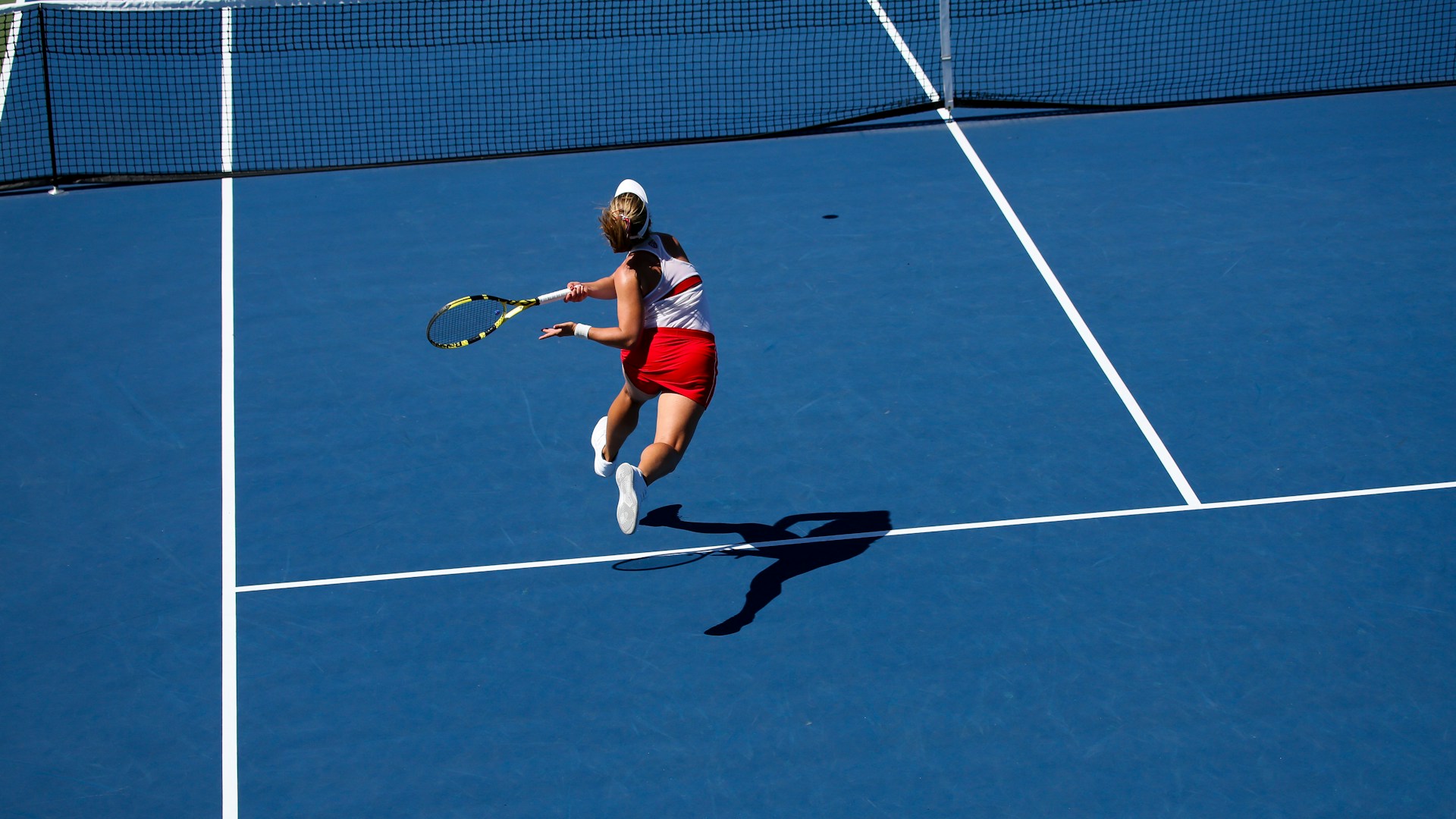a female tennis player in action on the court