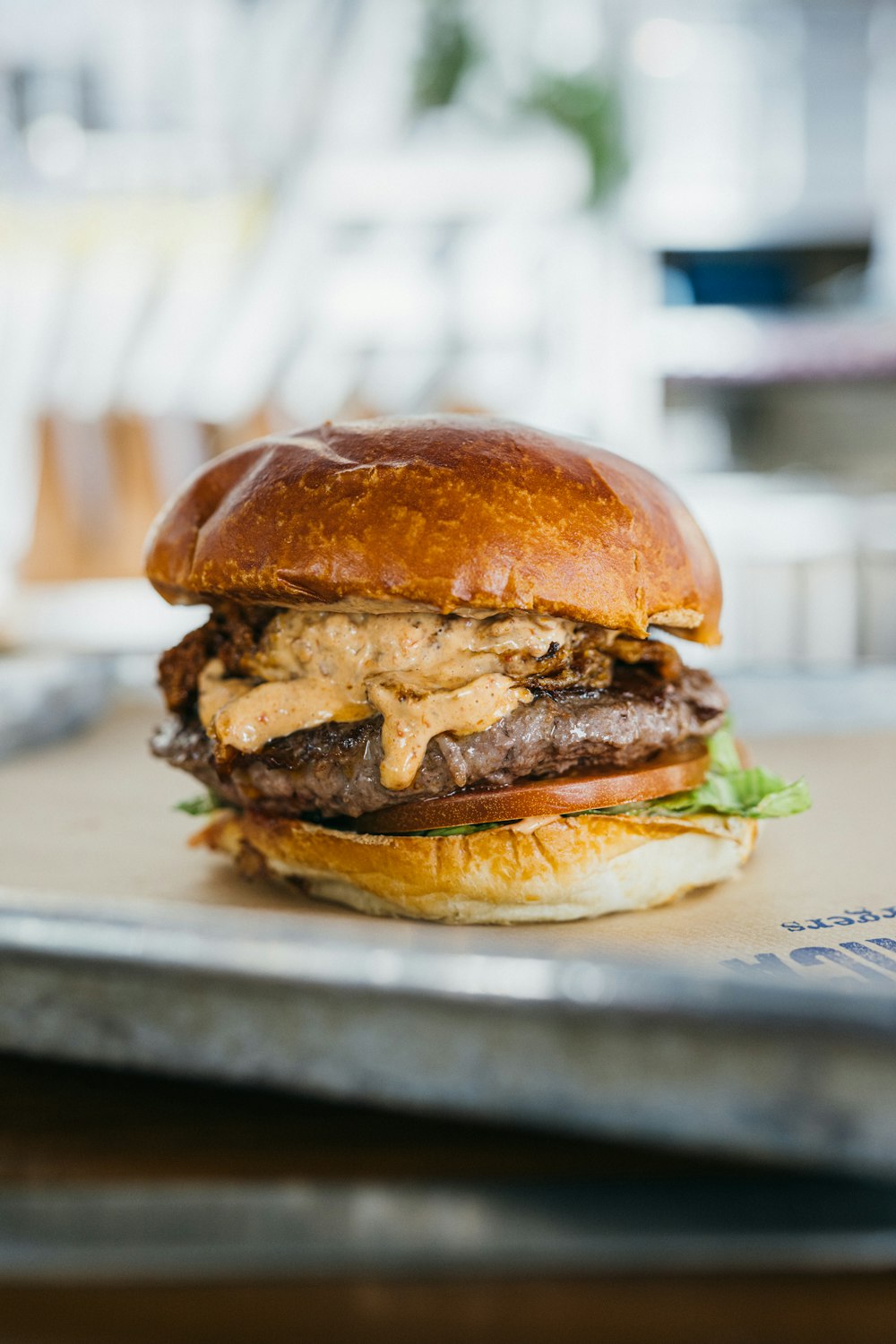 a hamburger sitting on top of a metal tray