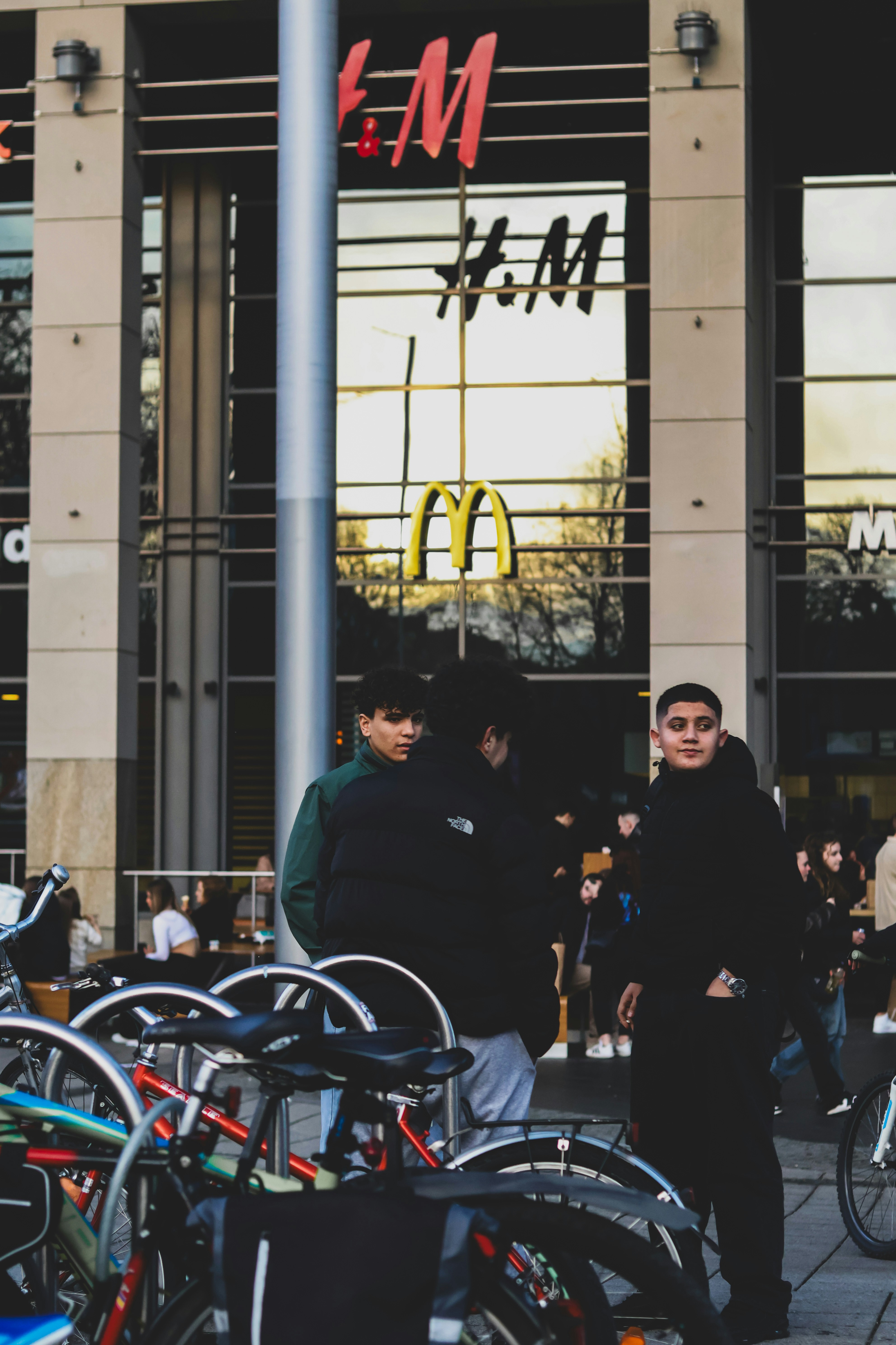 a group of people standing outside of a mcdonalds