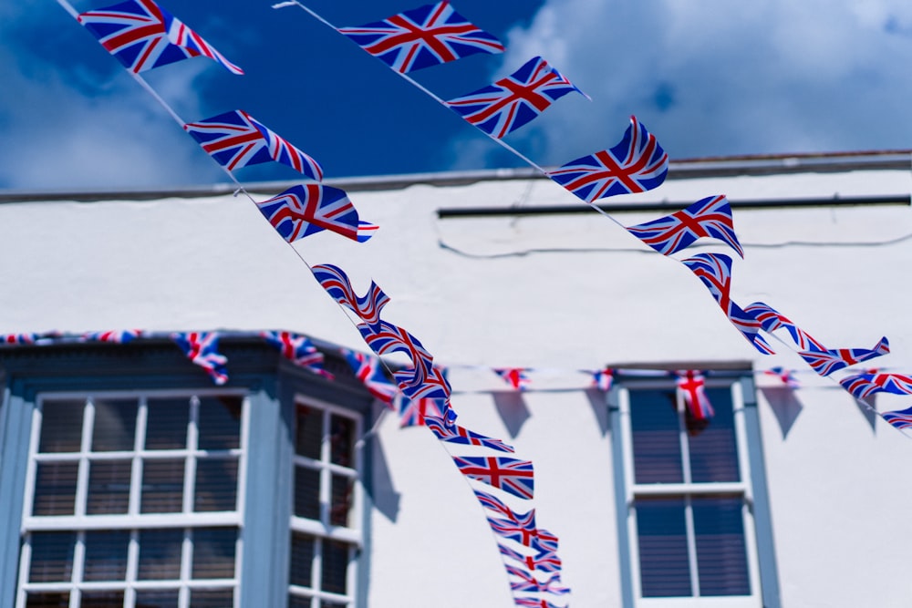 a bunch of flags that are in front of a building