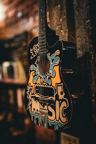a guitar hanging from the side of a wall