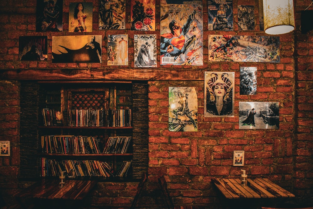 a brick wall covered in pictures and books