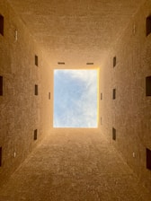 an empty room with a skylight in the middle