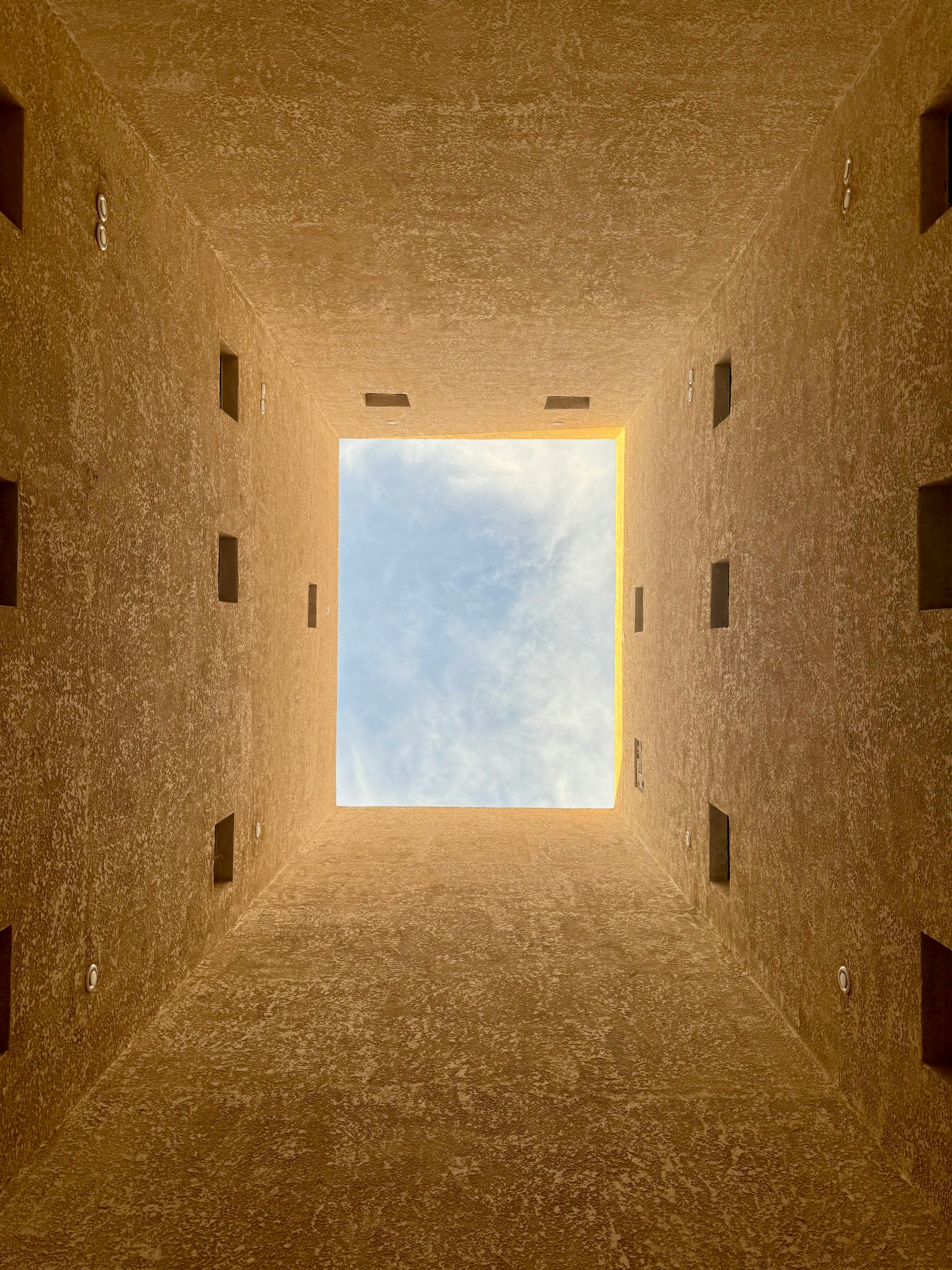an empty room with a skylight in the middle