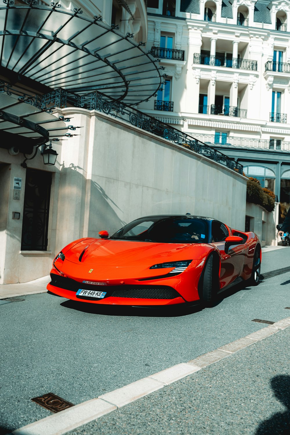 a red sports car parked on the side of the road