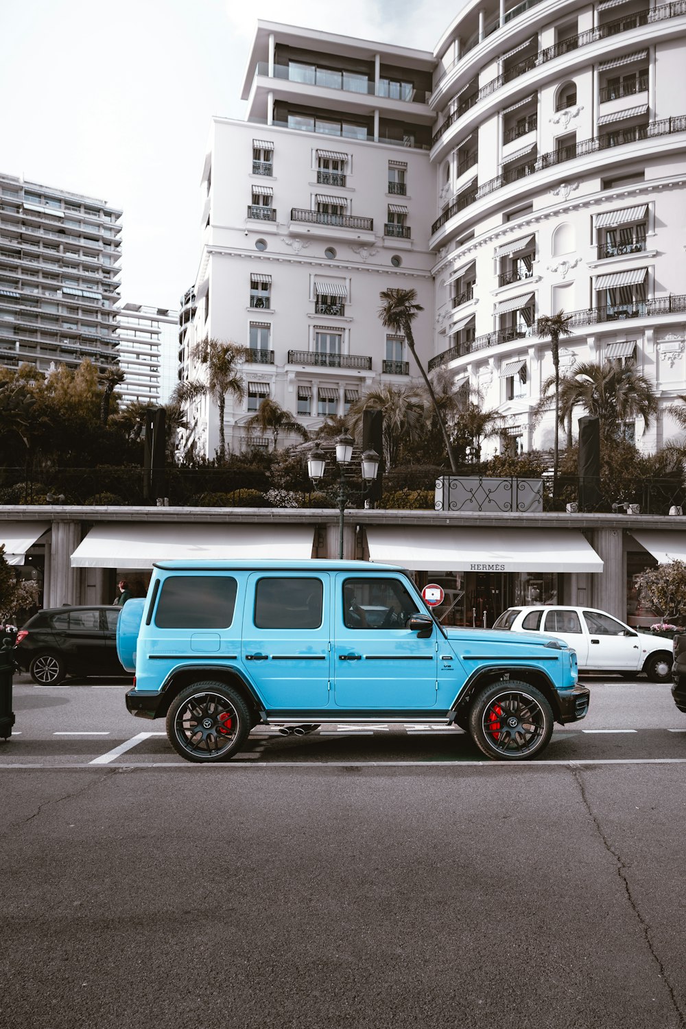 a blue jeep is parked in a parking lot