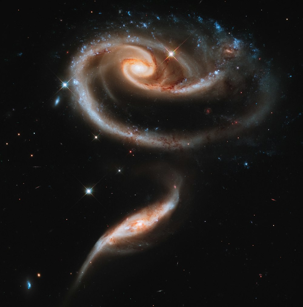 two spiral galaxy like objects in the sky