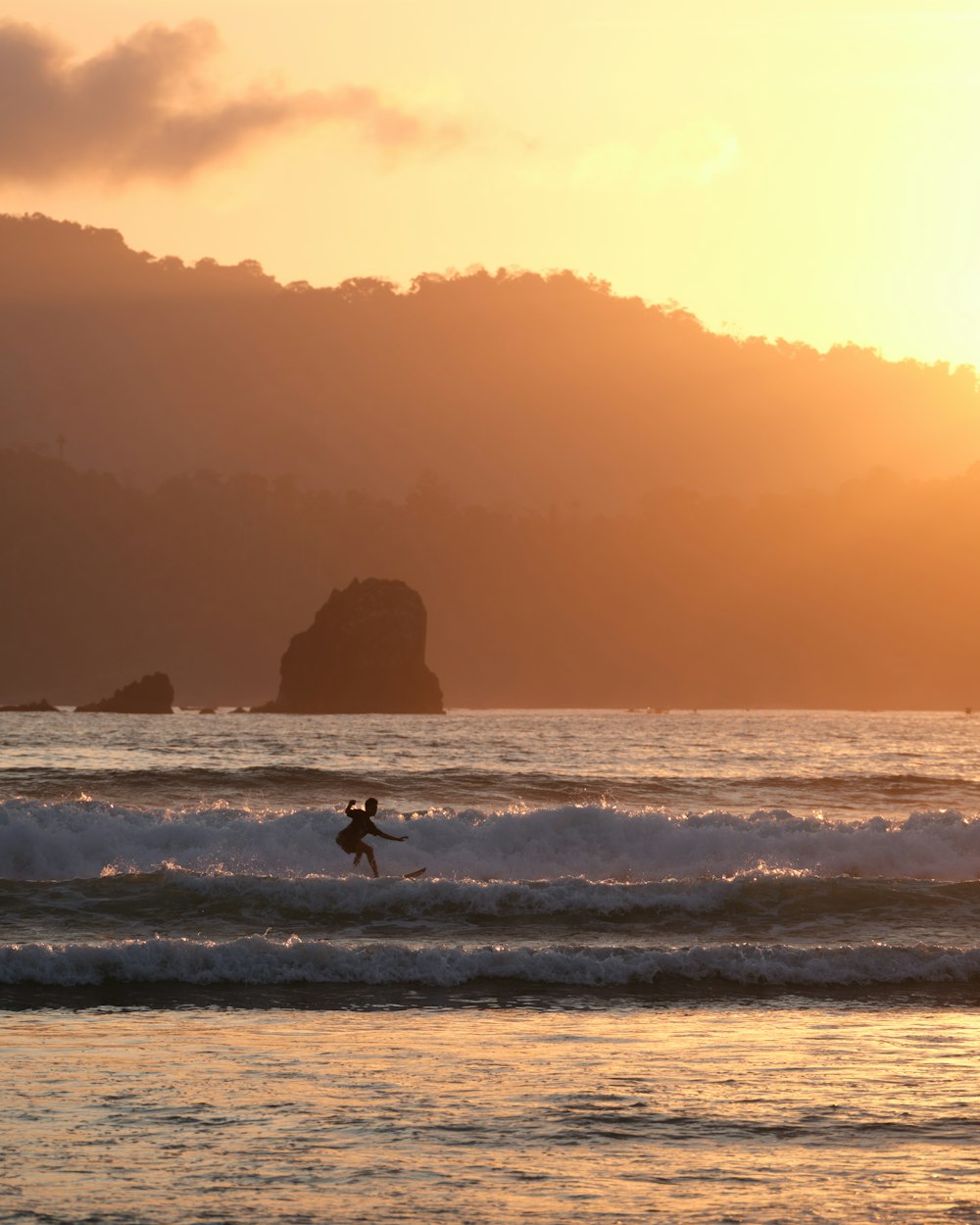 a person riding a surfboard on a wave in the ocean