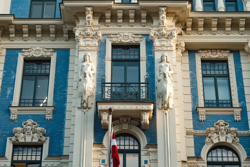 a blue and white building with a red and white flag